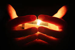 hands holding candle cropped.jpg?1437360